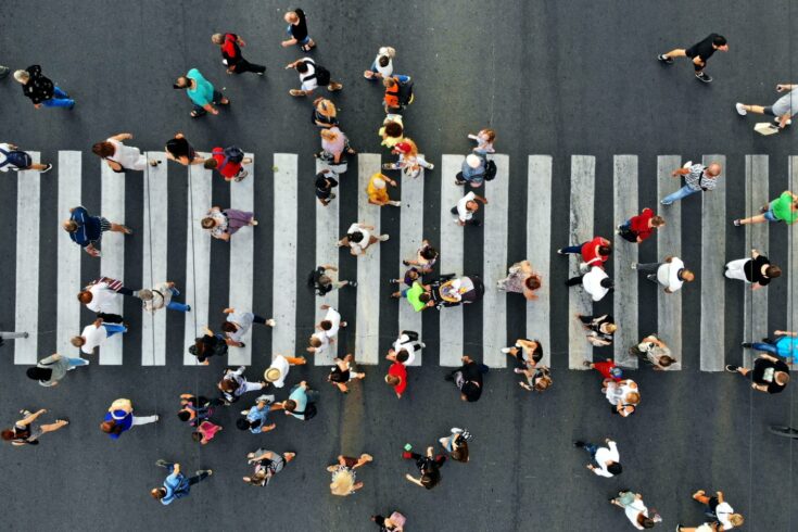 City centre crowd walking across a road