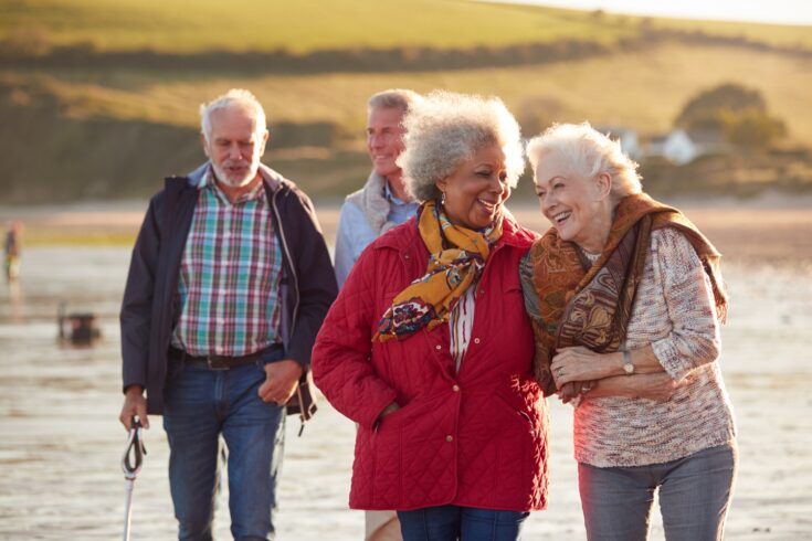 Older people walking on beach