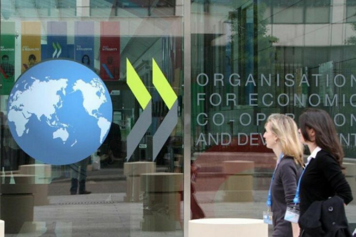 Two women walk past a window