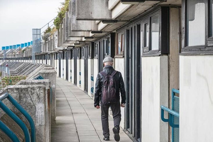 Man walking along housing estate