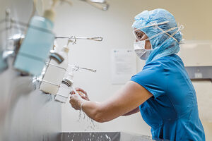 Nurse washing hands to avoid COVID-19 virus.