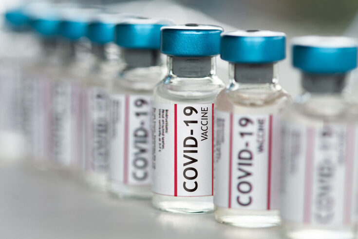 COVID-19 vaccine vials in a row