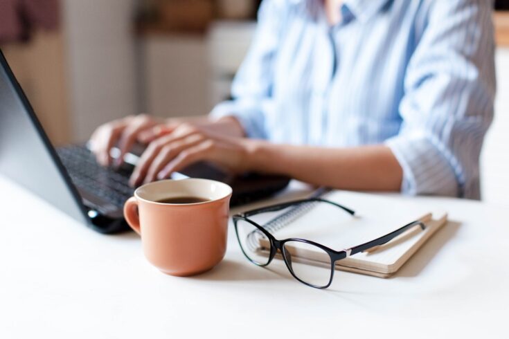 Woman working with laptop and coffee mug