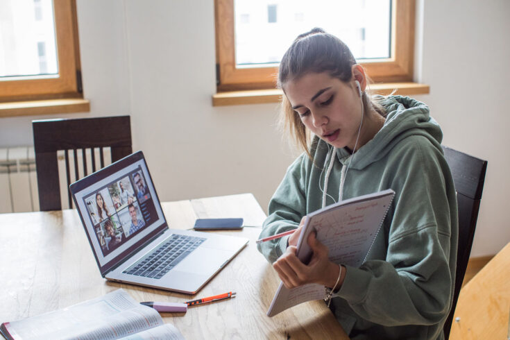 Young women at home during pandemic isolation learning