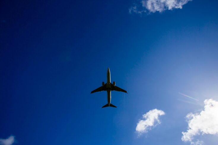 View of plane from below in blue sky