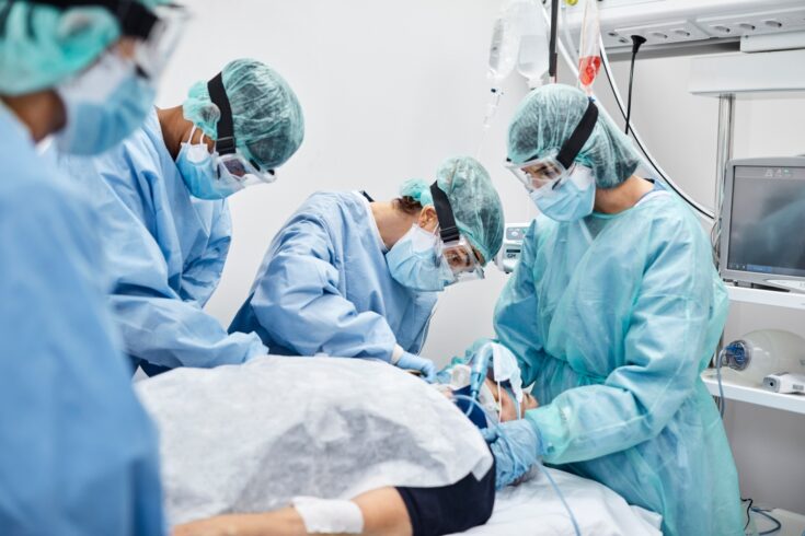 Frontline doctors and nurses treating a coronavirus patient in ICU