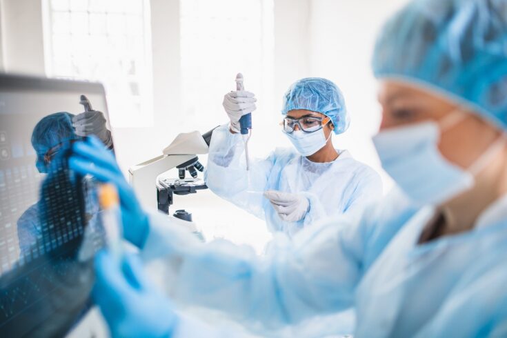 Scientists wearing full protective suit working in the laboratory