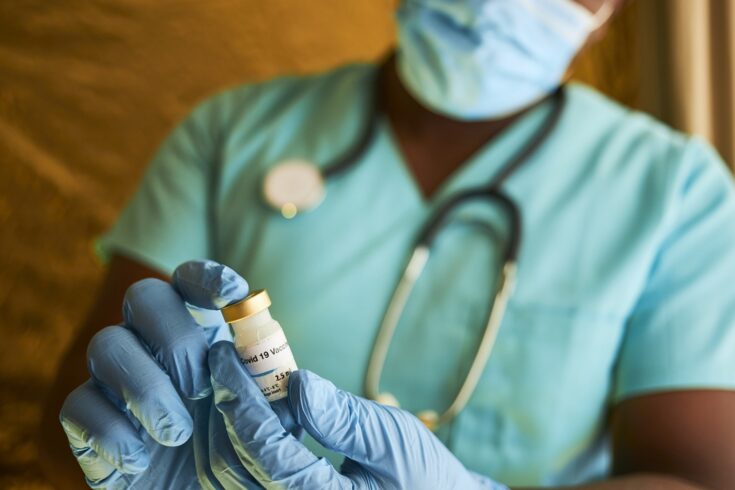 Doc holding vaccine vial