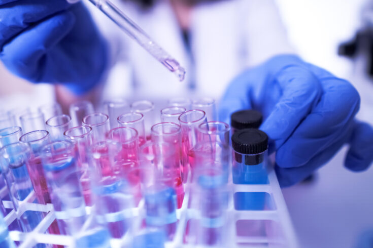 female lab technician doing research with a microscope in the lab