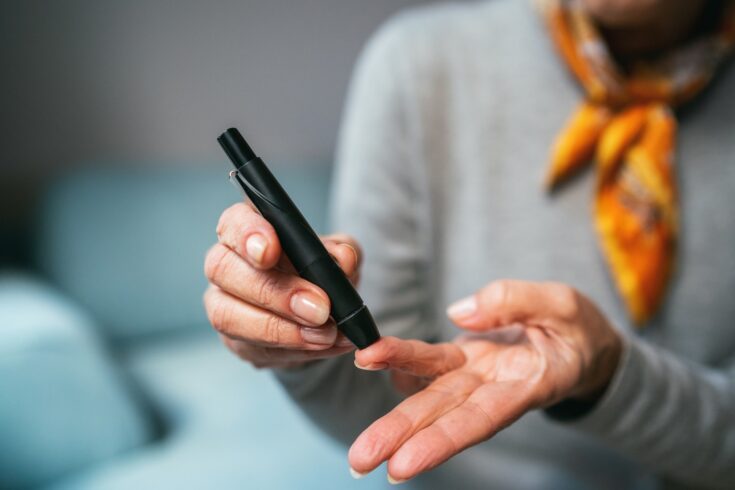 Senior woman doing Diabetes blood test at home