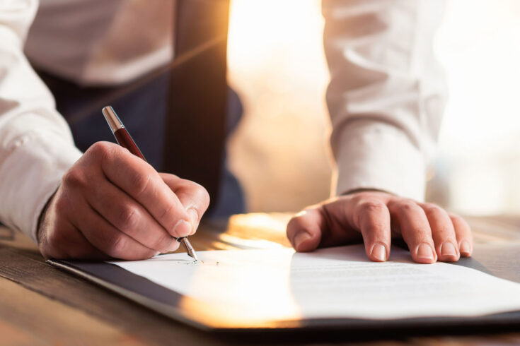 Businessman signing an official document