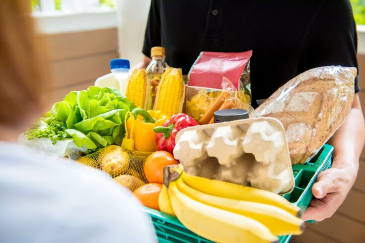 Delivery man delivering food to customer at home