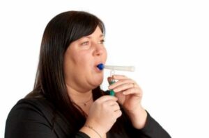 A woman using a BreathSpec sampler