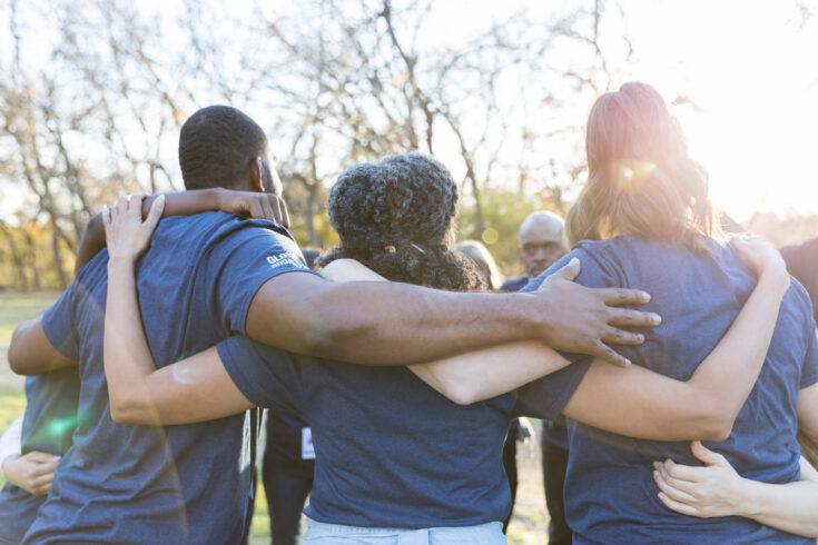 Rear view of united group of volunteers