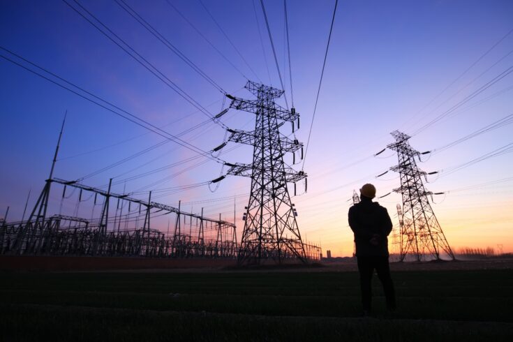 Electricity worker and pylon silhouette