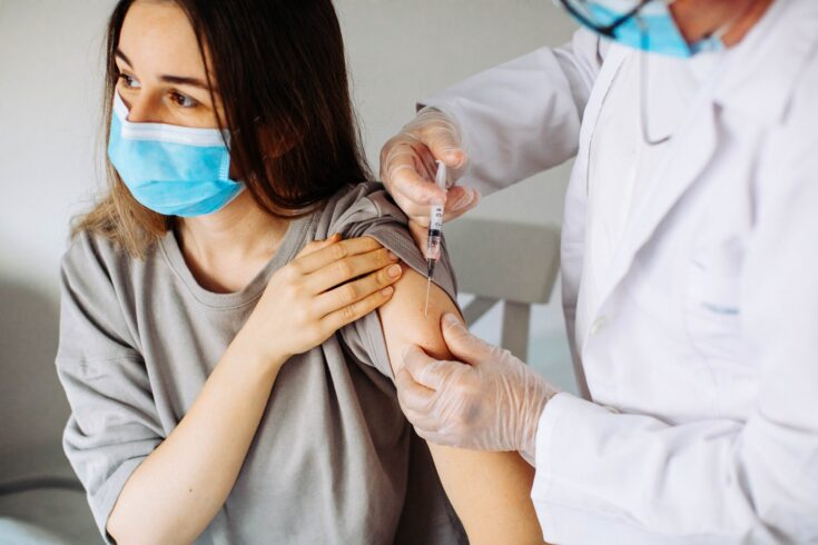 Young woman receiving coronavirus vaccine