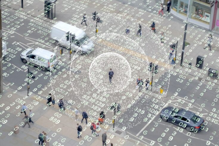 Aerial view of a street with data surrounding people