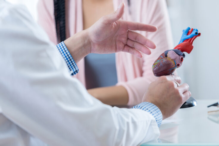 Male cardiologist discusses diagnosis with patient