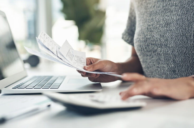 Closeup shot of an unrecognisable businesswoman calculating finances in an office