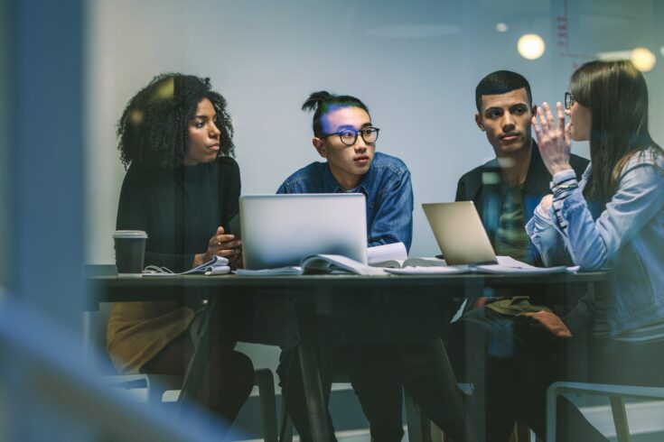 Group of young students working on an assignment