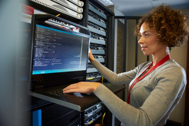 A woman works at a computer terminal