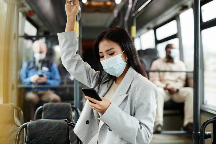 Woman Wearing Mask on Public Bus