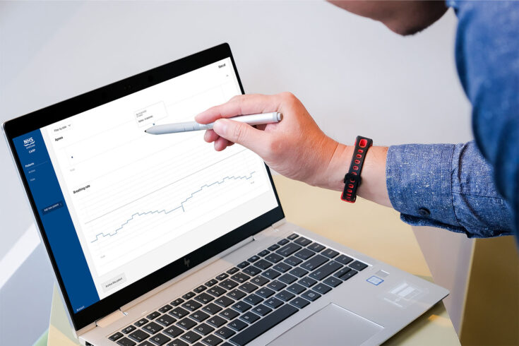 Person on laptop, analysing data on the NHS COVID-19 Advanced Respiratory Physiological (CARP) platform.
