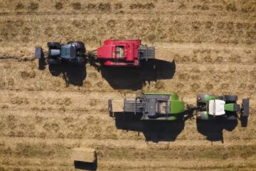 Aerial view of two tractors with harvesters