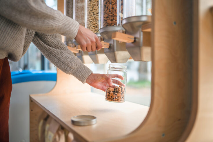 Close Up Of Using A Dispenser For Refilling In A Sustainable Plastic Free Shop