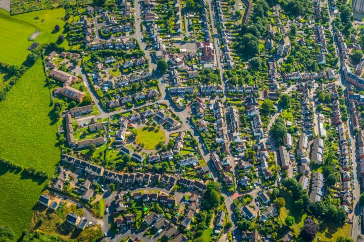 Aerial panorama over suburban homes gardens