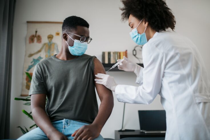 Young African American man receiving a COVID-19 vaccine