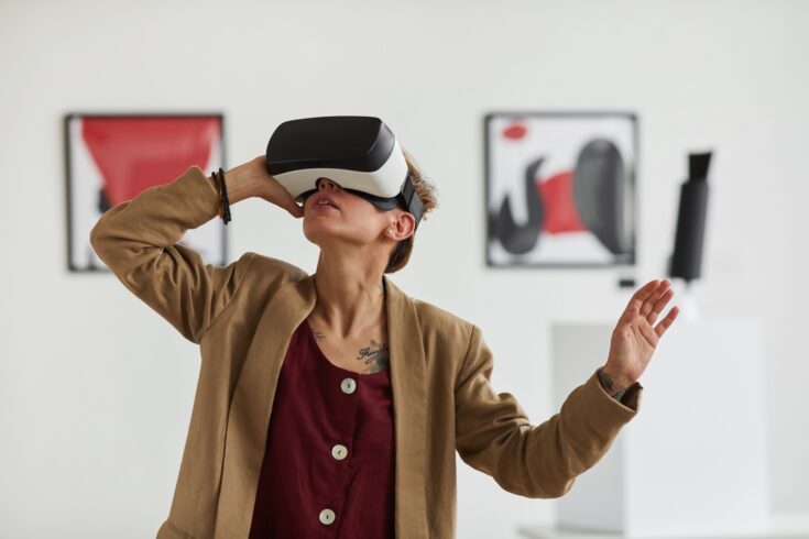 Young woman wearing virtual reality headset in museum of modern art