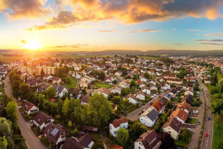 Aerial panorama of small town at sunrise