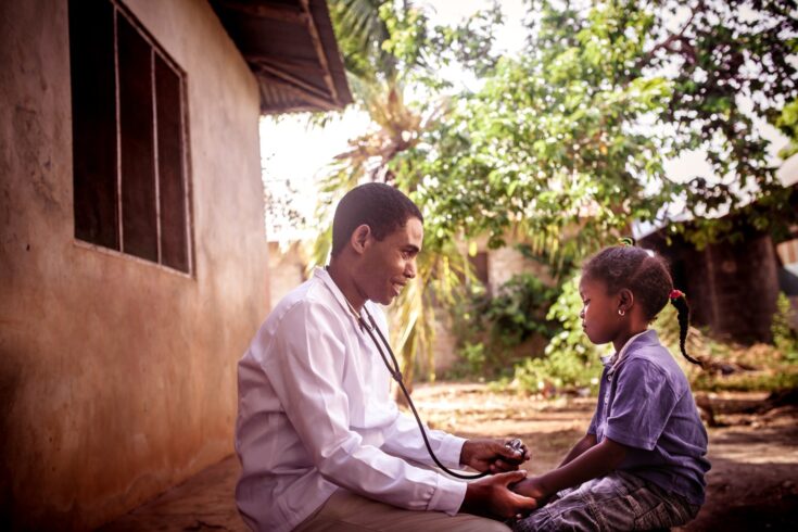 Doctor meeting with an African child