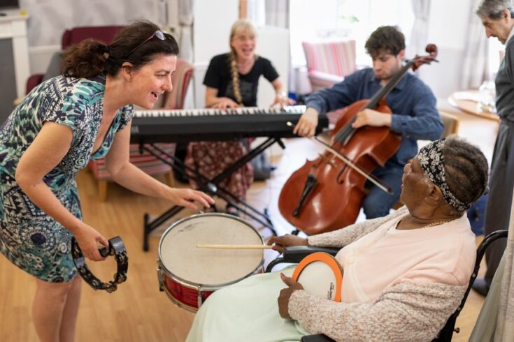 Group of people playing music for older people