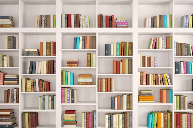 White bookshelves with various colorful books