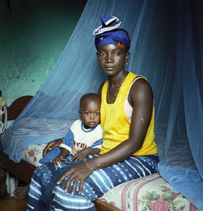 African woman and child with bed net