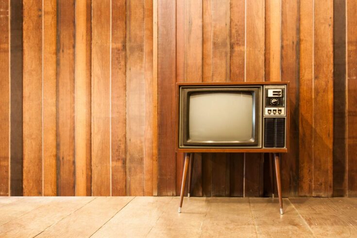 Brown old vintage-looking TV set placed against a brown wall