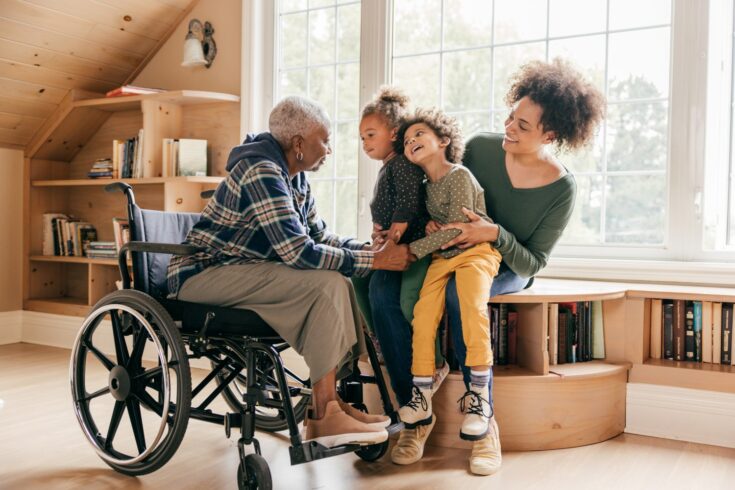 A grandson and grandmother holding hands during conversation