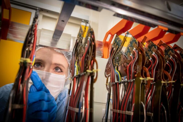 A close-up shot of a woman looking at the Vertex Locator detector.