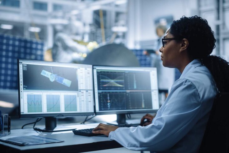 Female engineer on the computer, calculating orbital trajectory tracking