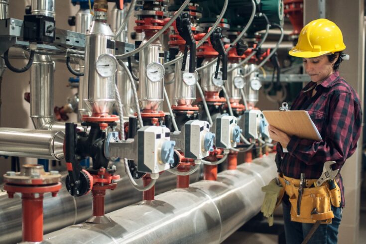 Female technician at work in boiler room