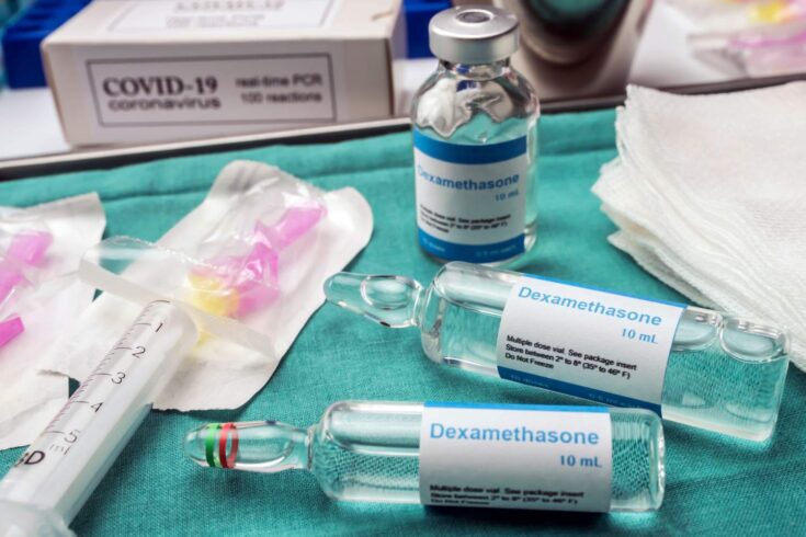 Medical syringe and medical bottles labelled dexamethasone on a medical table
