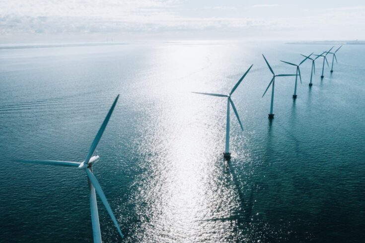 Offshore wind turbines lined up in the ocean