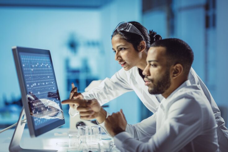 Scientists working in a laboratory, using touch screen