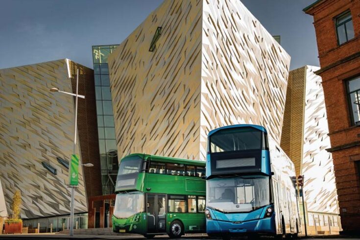 Two modern double-decker buses parked outside modern building