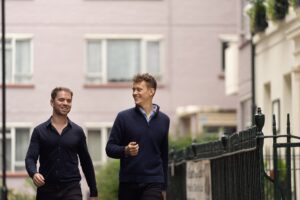 Two men walking in urban environment