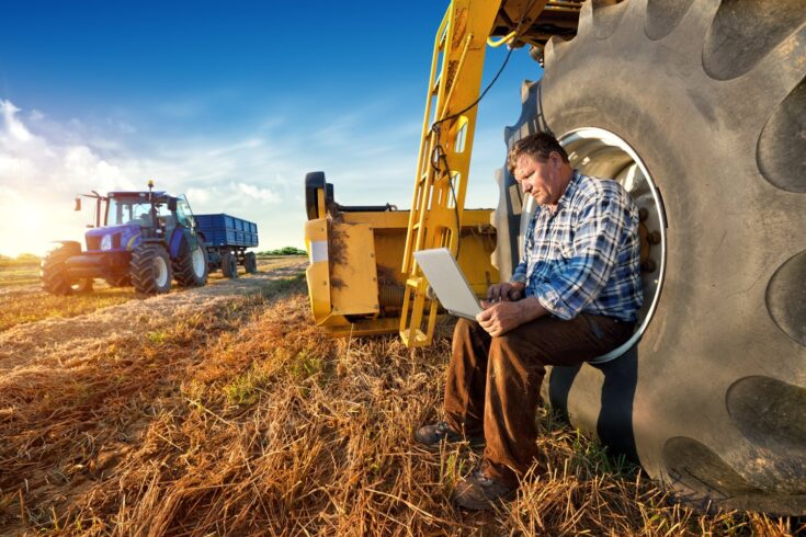 Farmer counts yields on a computer