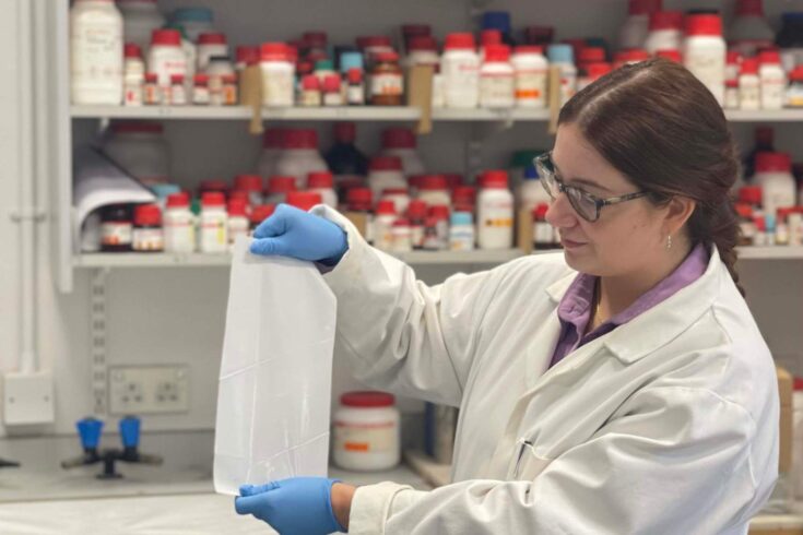 A researcher holding the self-sterilising film in a lab