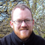 A headshot of Richard Evans smiling